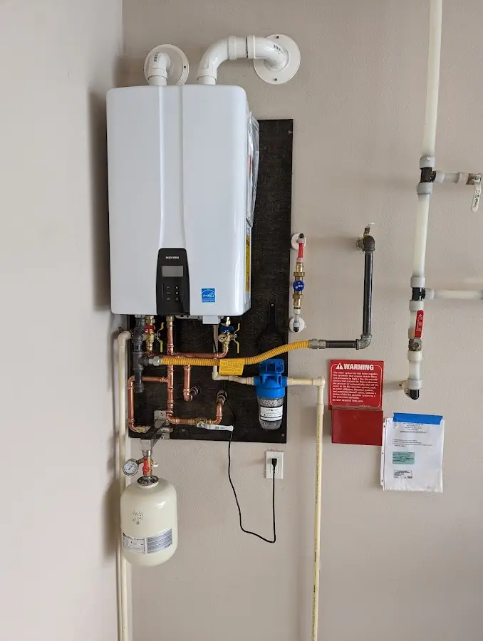 Professional plumber installing copper piping in a Pasco home